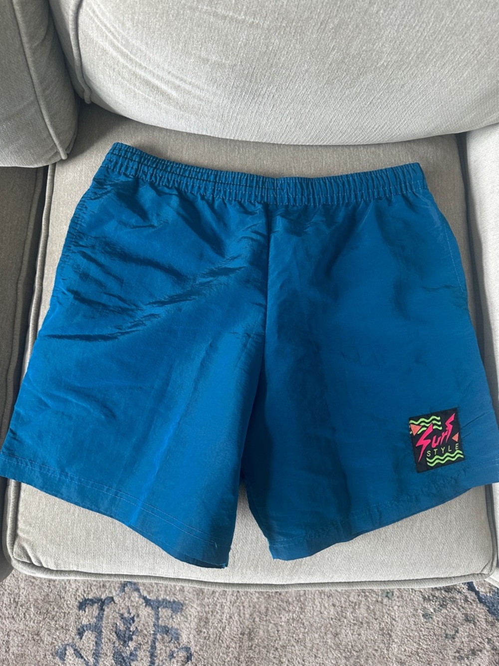 surf style Black Patch Logo on Teal Fabric with Neon Pink and Neon Green Accents